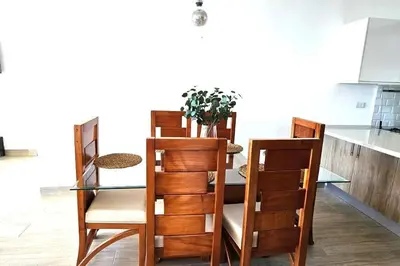a dining room with a table and four chairs at New 2 BR apt with swimming pool at playa bonita in Las Terrenas