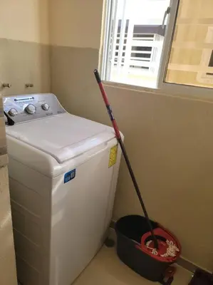 a mop sitting on top of a toilet in a bathroom at comodidad y tranquilidad in Mendoza
