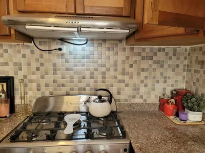 a kitchen stove top with a tea kettle on it at comodidad y tranquilidad in Mendoza