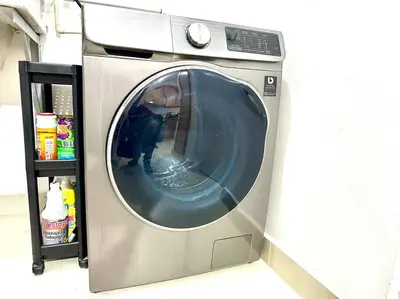 a washing machine is sitting next to a shelf at Vista Panorama Cipres in Hato Mayor