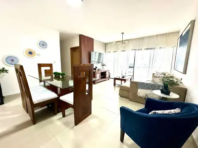 a living room with a blue couch and a table at Vista Panorama Cipres in Hato Mayor