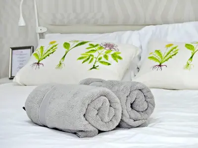 a pile of towels sitting on a bed with pillows at Villa Olga Studio in Rincón Largo