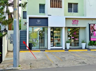 a red arrow on a pole in front of a store at Villa Olga Studio in Rincón Largo