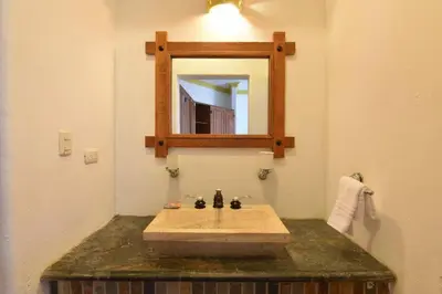 a bathroom with a sink and a mirror at Bluefish Condo, Ocean Front, Sunrises, Pool, Hot Tub, Under New Management in Sosúa