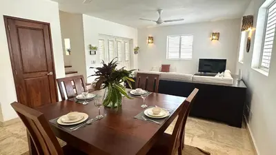 a dining room with a table with chairs and a couch at Villa 4Bdrms 3.5baths with pool, Jacuzzi and Starlink WiFi in Las Terrenas