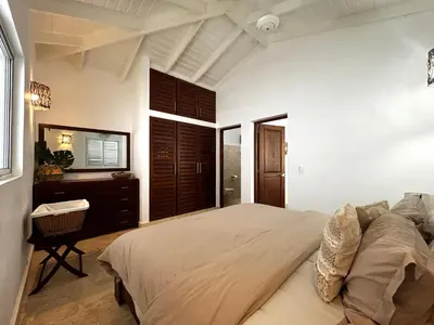 a bedroom with a large bed and a desk at Villa 4Bdrms 3.5baths with pool, Jacuzzi and Starlink WiFi in Las Terrenas