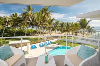 a view of the pool and beach from the balcony of a resort at Direct View and Access to Beach! in Eslabón