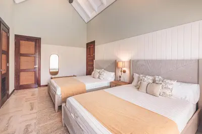 a hotel room with two beds and a window at Apartment nearby the beach at Portillo RAA in Las Terrenas
