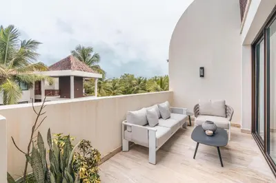 a balcony with a couch and a table at Apartment nearby the beach at Portillo RAA in Las Terrenas