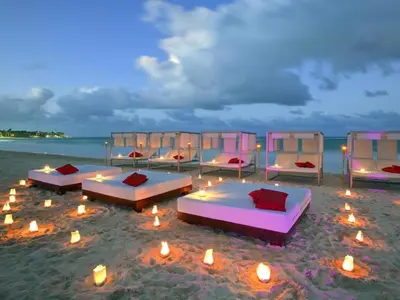 a group of beds on the beach at night at Paradisus Punta Cana Resort All Inclusive in Punta Cana