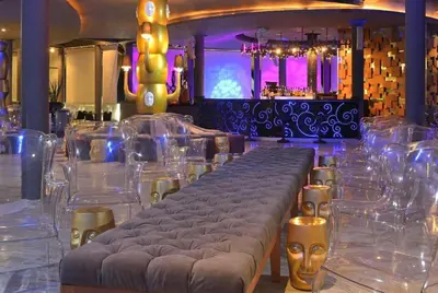 a bar with a long table and clear chairs at Paradisus Punta Cana Resort All Inclusive in Punta Cana