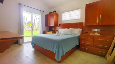 a bedroom with a bed with a dresser and a window at Brisa Atlántico - Secluded Beach in La Piña