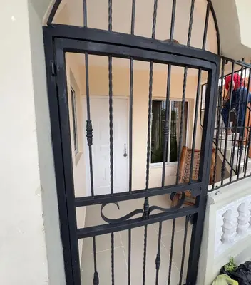 a iron door with a mirror on a wall at Tu casa los frailes 2da in La Alianza