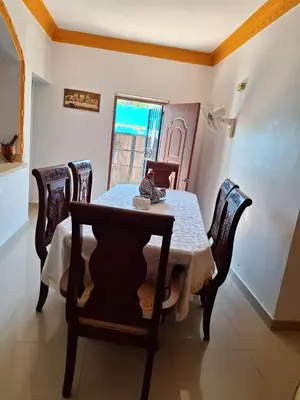 a dining room with a table and chairs and a window at Casa Rural con Piscina in Azua de Compostela
