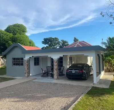 a house with a car parked in the driveway at Romeos Place in Las Coles