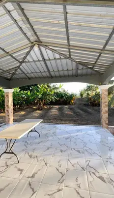 a picnic table under awning on a patio at Romeos Place in Las Coles