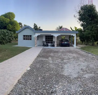 a house with a car parked in the driveway at Romeos Place in Las Coles