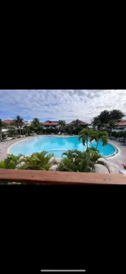 a view of a large swimming pool with palm trees at Residencial Paraiso C102 in Bayahibe