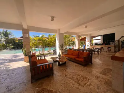 a living room with orange couches and a table at Residencial Paraiso C102 in Bayahibe