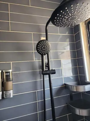 a black lamp in a kitchen next to a wall at Rooftop Apartment in Villa Francisca