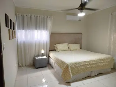 a bedroom with a bed and a ceiling fan at Apartamento próximo al centro médico HOMS in Hato Mayor