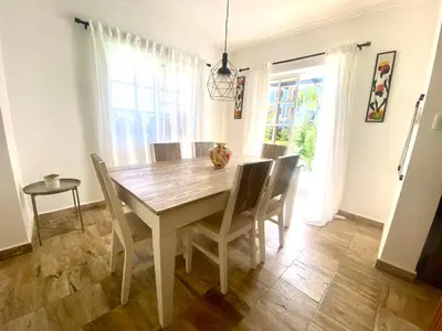 a dining room with a wooden table and chairs at The Perfect Place for Holiday in los Corales RD in Punta Cana