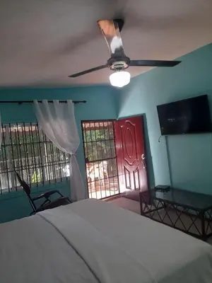 a bedroom with a bed and a red door at Villabenedetta santo domingo in Varía