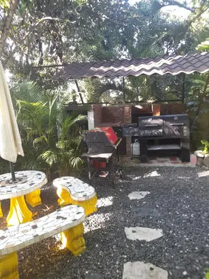 a patio with a piano and benches and an umbrella at Villabenedetta santo domingo in Varía