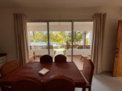 a dining room with a table and a large window at Residencial Paraíso A101 in Bayahibe