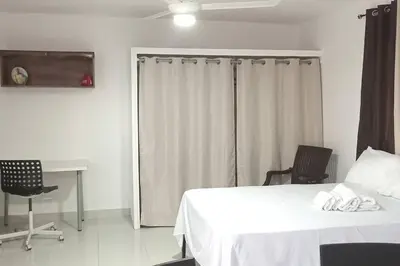 a bedroom with a bed and a table and chairs at Aparta estudio 2 El Cacique, próximo malecón SD in Santo Domingo