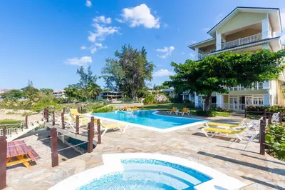 a villa with a swimming pool and a house at Los Balcones, Sosua, Ocean Front! in Sosúa