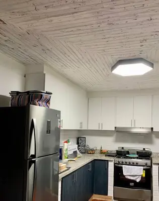a kitchen with a stainless steel refrigerator and blue cabinets at Villa Carmen en Jarabacoa in La Represa