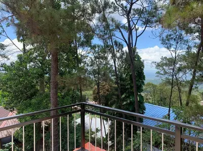 a balcony with a view of the trees at Villa Carmen en Jarabacoa in La Represa