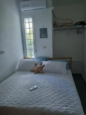 a large bed with a starfish on top of it at A private cozy-beach apartment in Dominicus in La Laguna