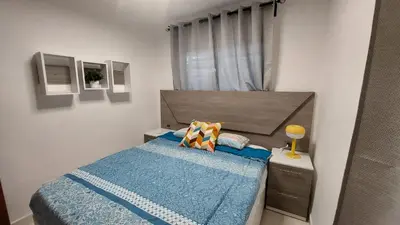 a small bedroom with a bed with a blue blanket at Apartamento Residencial sembrador 3 ciudad Juan Bosch in La Javilla