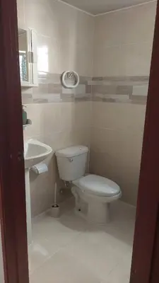a bathroom with a toilet and a sink at Apartamento Residencial sembrador 3 ciudad Juan Bosch in La Javilla