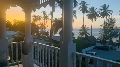 a view of the ocean from the porch of a house at Beachfront Unit with Stunning Sunsets and Starlink Internet ! in Las Terrenas