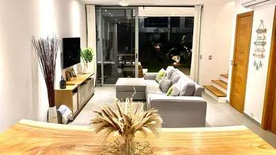a living room with two couches and a table at Modern Zen Villa Next to Playa Popy in Las Terrenas