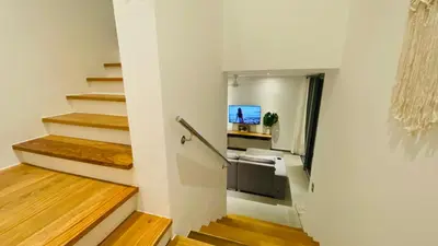 a hallway with stairs and a kitchen in a house at Modern Zen Villa Next to Playa Popy in Las Terrenas