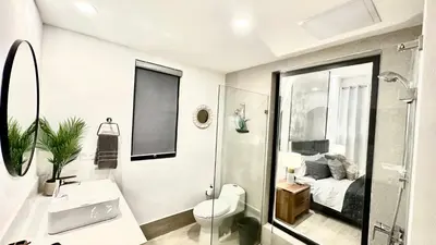 a bathroom with a sink and a toilet and a bed at All-New Zen Apartment with TreeTops and Ocean Views ! in Las Terrenas