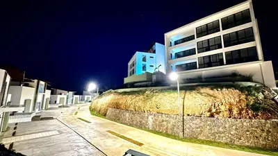 a building at night with street lights in front at All-New Zen Apartment with TreeTops and Ocean Views ! in Las Terrenas
