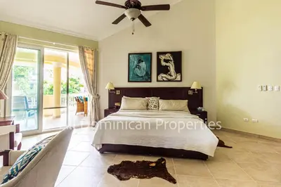 a bedroom with a bed and a ceiling fan at Hispaniola Beach Official, Sosua! in Sosúa