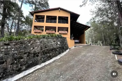 a house with a stone wall next to a road at Vintage Cabin GB in Constanza