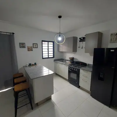 a kitchen with a black refrigerator and a stove at Santo Domingo Este in Ensanche Savica de Mendoza