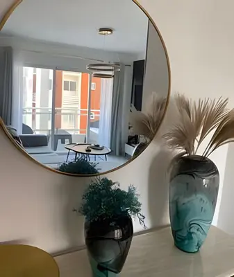 a mirror in a room with two vases on a table at Stylish 3BR,2BA in Santo Domingo Este in Mendoza