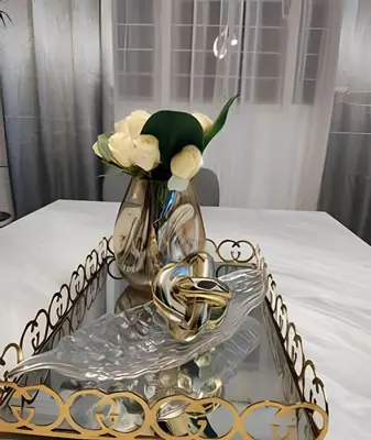 a glass tray with a vase with flowers on a table at Stylish 3BR,2BA in Santo Domingo Este in Mendoza