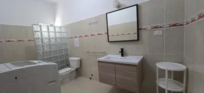 a bathroom with a sink and a toilet and a mirror at Apartamentos confortables in La Barbacoa