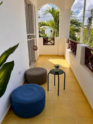 a living room with a blue ottoman and a table at Apartamento Aurora in Bayahibe