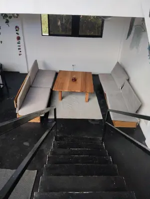 a room with two beds and a table and stairs at Casa Santa la laguna in La Aguada