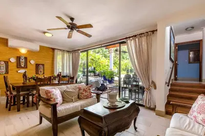 a living room with a couch and a table at Villa Cajuiles 13, Casa de Campo in La Romana